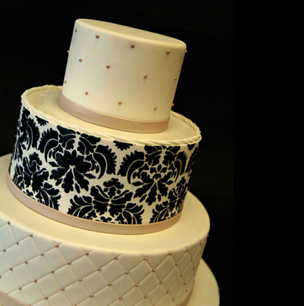 Available in chocolate and vanilla, this three-tier round cake is covered in champagne fondant and topped off with shimmering, champagne-coloured fondant bands at the base of each tier. Image: Pink Cake Box