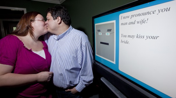 Confessed geeks Miguel Hanson and Diana Wesley were married last week - by a virtual minister programmed by the groom. Image source: David J. Phillip - AP Confessed geeks Miguel Hanson and Diana Wesley were married last week - by a virtual minister programmed by the groom.