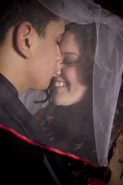 The bride's aunt hand-sewed the red ribbon around the veil.