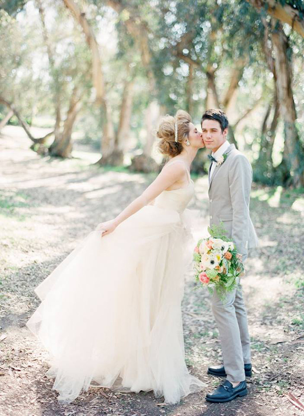 bride kissing her groom on the cheek
