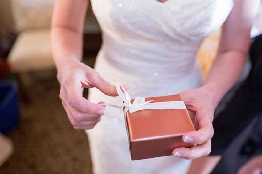 bride-opening-gift-from-husband-on-wedding-day