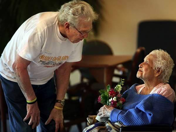 giving flowers to elderly people in homes