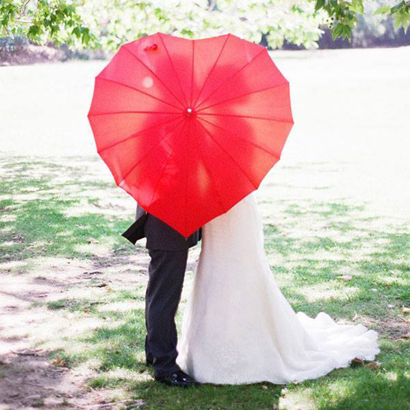 heart shaped umbrella and a wedding couple