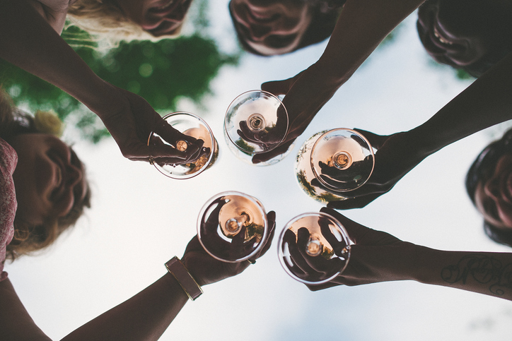 Woman toasting with sparkling wine and champagne