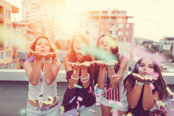 Happy hen party do girls partying on rooftop terrace