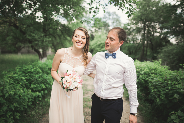 Luxury married wedding couple, bride and groom posing in park.