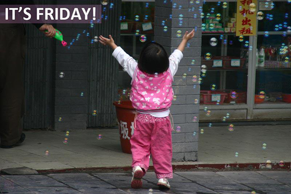 little girl dancing in soap bubbles
