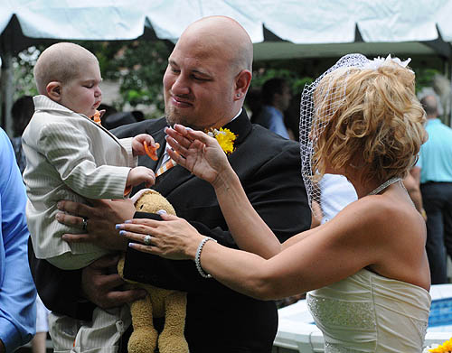 The bride, Christine Swidorsky, and groom, Sean Stevenson, enjoy a few precious moments with their dying son on their wedding day. Image:  Tony Tye/Post-Gazette 
