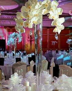 high orchids as center piece on wedding tables