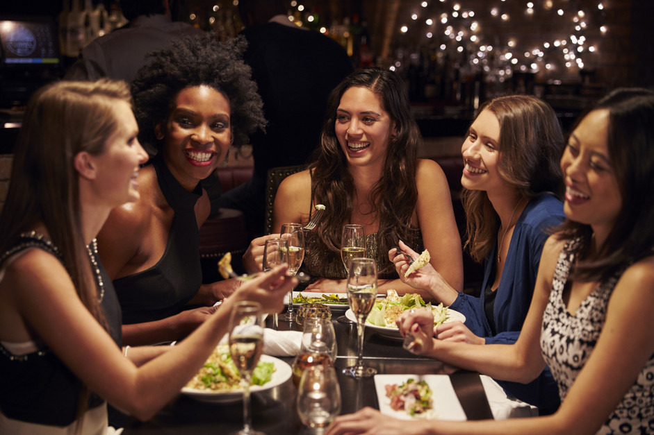 Group Of Female Friends Enjoying Meal In Restaurant